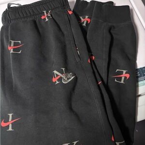 Nike Black Sweatpants with Red Swoosh Details